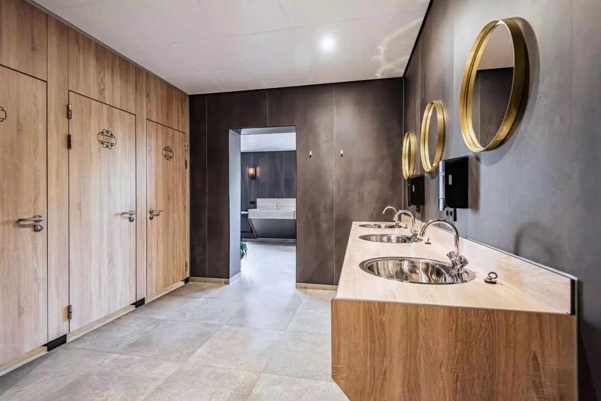 Man holding bike while standing on gray mountain