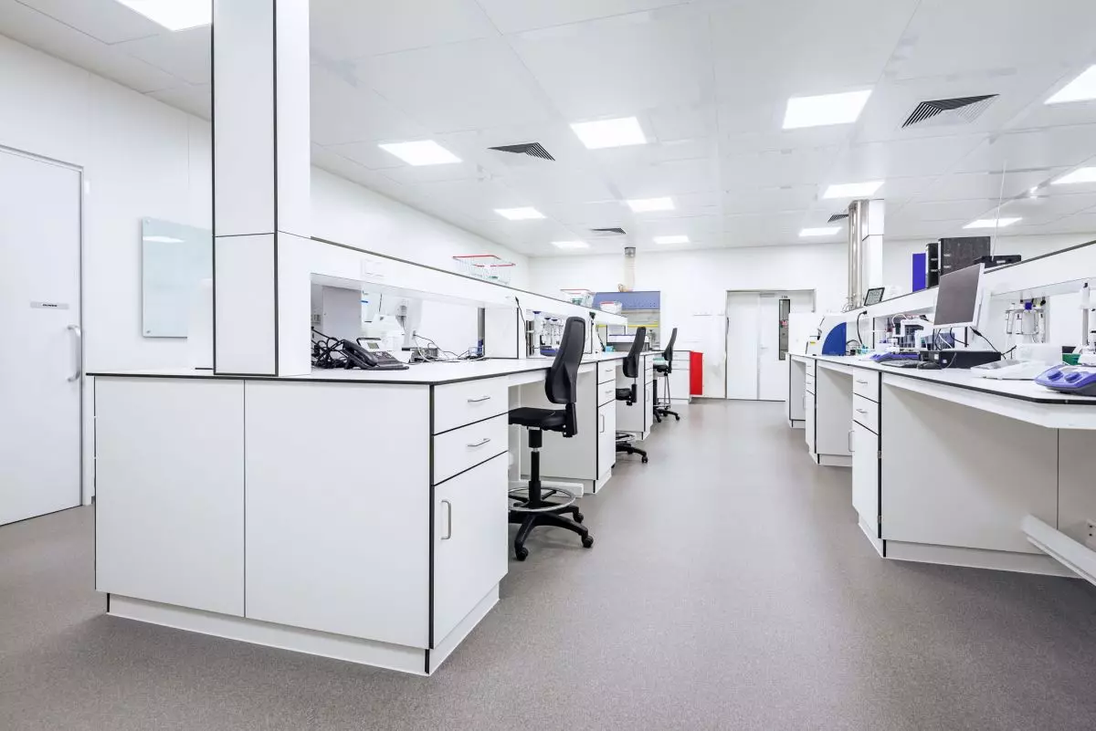 Man holding bike while standing on gray mountain