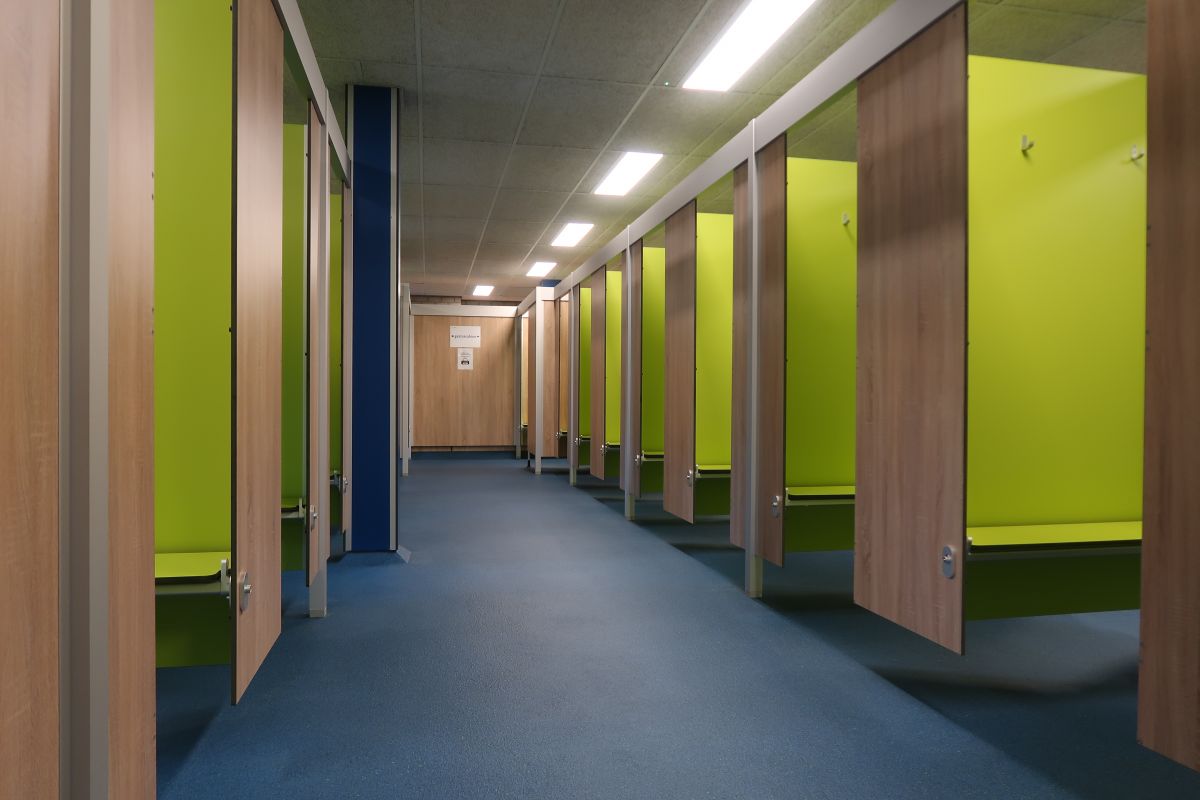 Man holding bike while standing on gray mountain